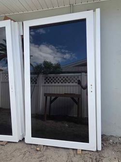 Brand New 143.5W x 90.5H PGT Impact Vinyl Sliding Door with Frame and Handles.