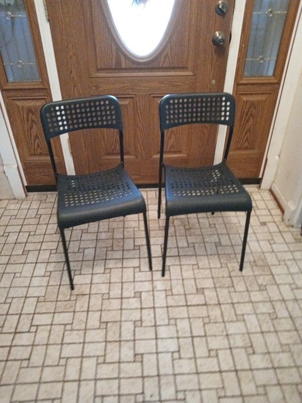 Set Of Stackable Black Plastic And Metal Chairs 