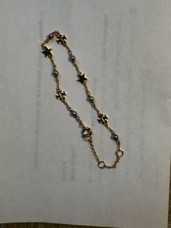 Tory Burch gold tone bracelet with stars and beads