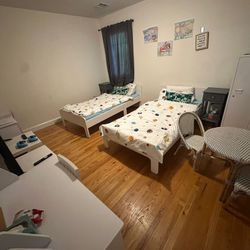 Two Beds With Desks And Side Table