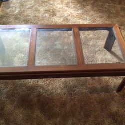 Beautiful brown coffee table with three glasses on it