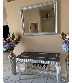 Entry marble table with mirror and vases