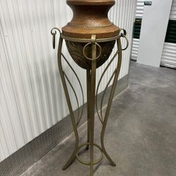 Hollywood Regency style wrought iron pedestal plant stand featuring a curvaceous Roman urn silhouette.   63” high , 15” round   $250