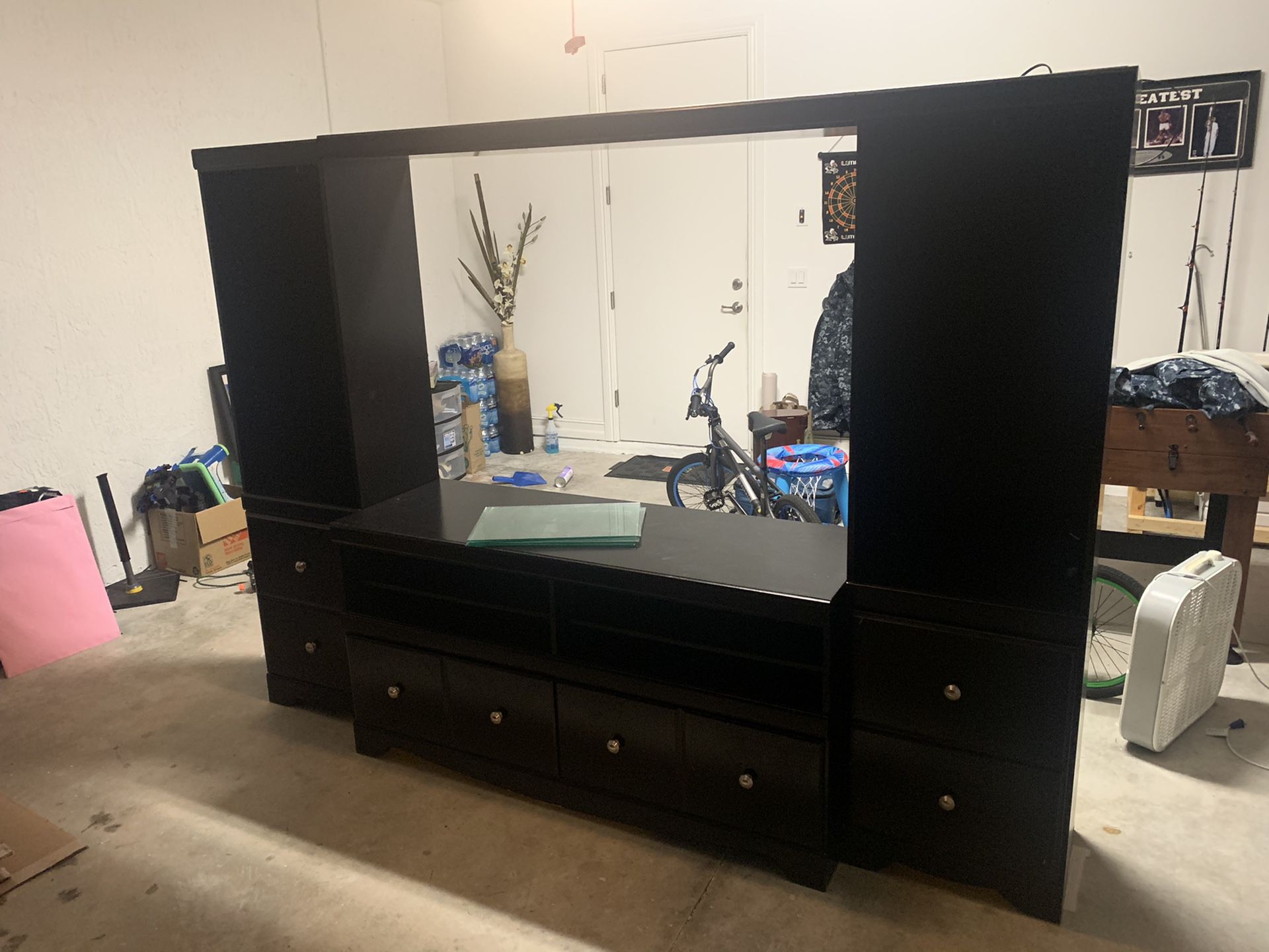 Full 4 piece entertainment center with 4 glass shelves. Both columns have lighting as well. Tons of storage and very clean.