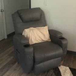 Gray leather reclining massage. He’s also a Lyft.