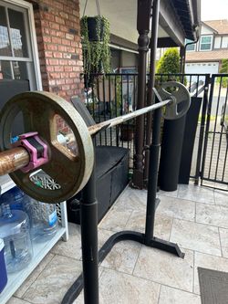 Squat rack, 45 pd dumbbell with 2x25s,