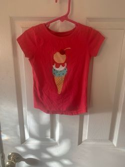 Cute red short-sleeve T-shirt featuring a colorful ice cream cone with a cherry design on the front.