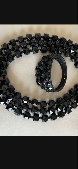 It’s two pieces necklace and bracelet. The color is black.