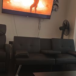 Small black futon sofa and recliner w/ massager 