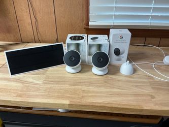 2 Google nest indoor outdoor battery cameras , solar panel for charging outside , stand for charging inside