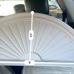 half-round sunburst architectural pediment, a decorative element used above doors or windows