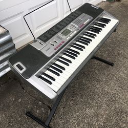 Casio LK-210 Keyboard with music stand and keyboard Stand  Really cool because it Lights up the keys that are being played even in demo mode  $60 cash