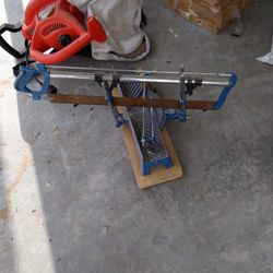 A Nice metal miter saw. The Saw by itself Covers The Price. One of the metal loops is broken 