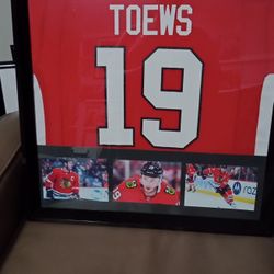 JOHNATHAN TOWES OF THE CHICAGO BLACK HAWKS, CUSTOM BRANDED, AUTHENTIC FRAMED JERSEY.