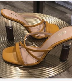yellow Zara strappy sandals with a square toe and block heel.