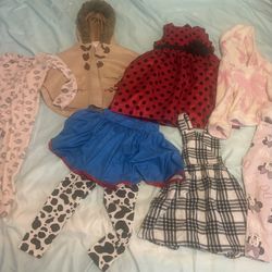 Cute bundle of baby girl clothes! Red polka dot dress, tan hooded poncho, pink Minnie Mouse leggings, and a blue skirt with cow print leggings (Toy St