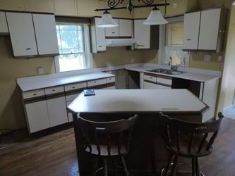 White Kitchen Cabinet with Laminate Counters, island, additional 10'6" with upper and lower cabinets including sink and faucet, includes 2 chairs