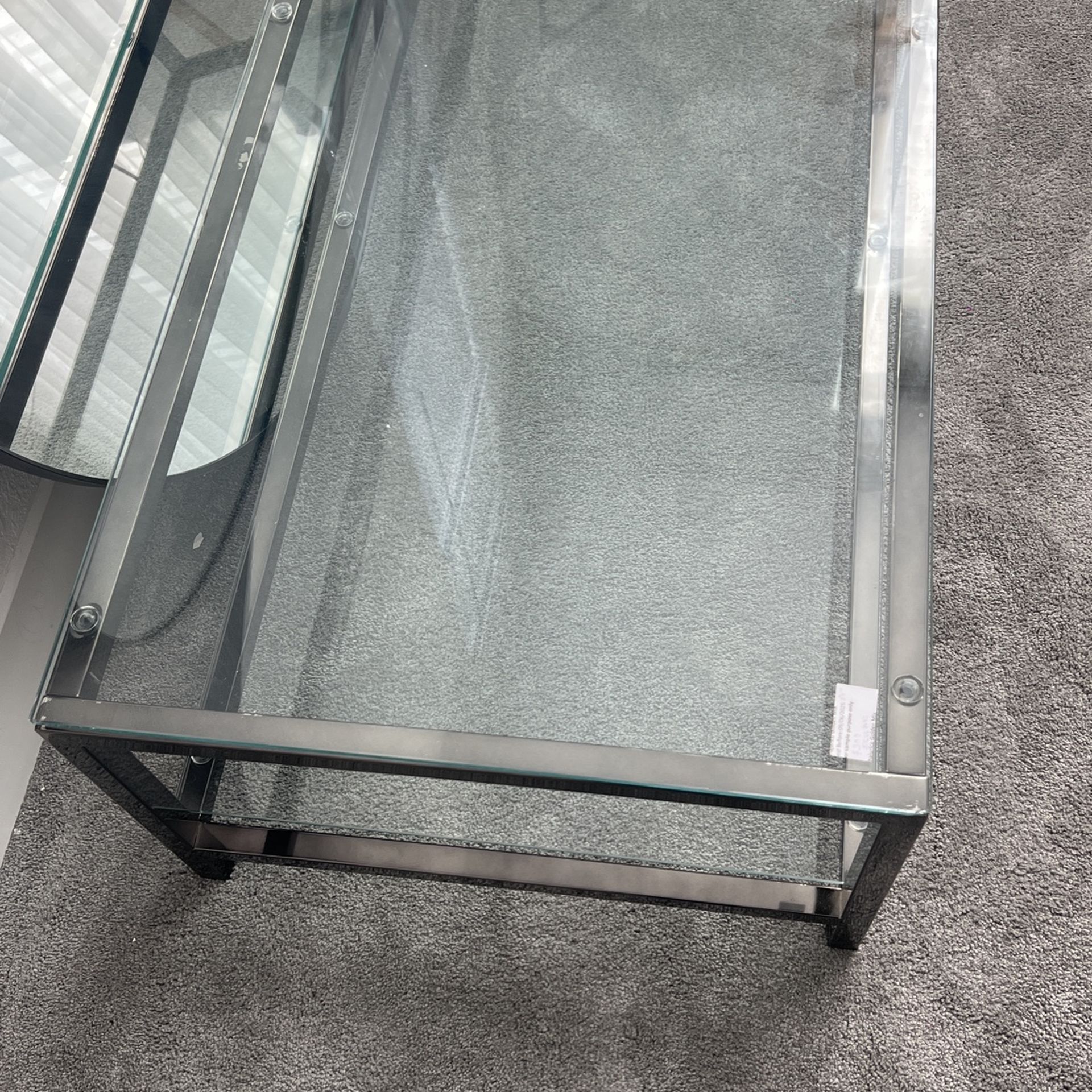 54" Clear Glass and Steel Coffee Table with Shelf