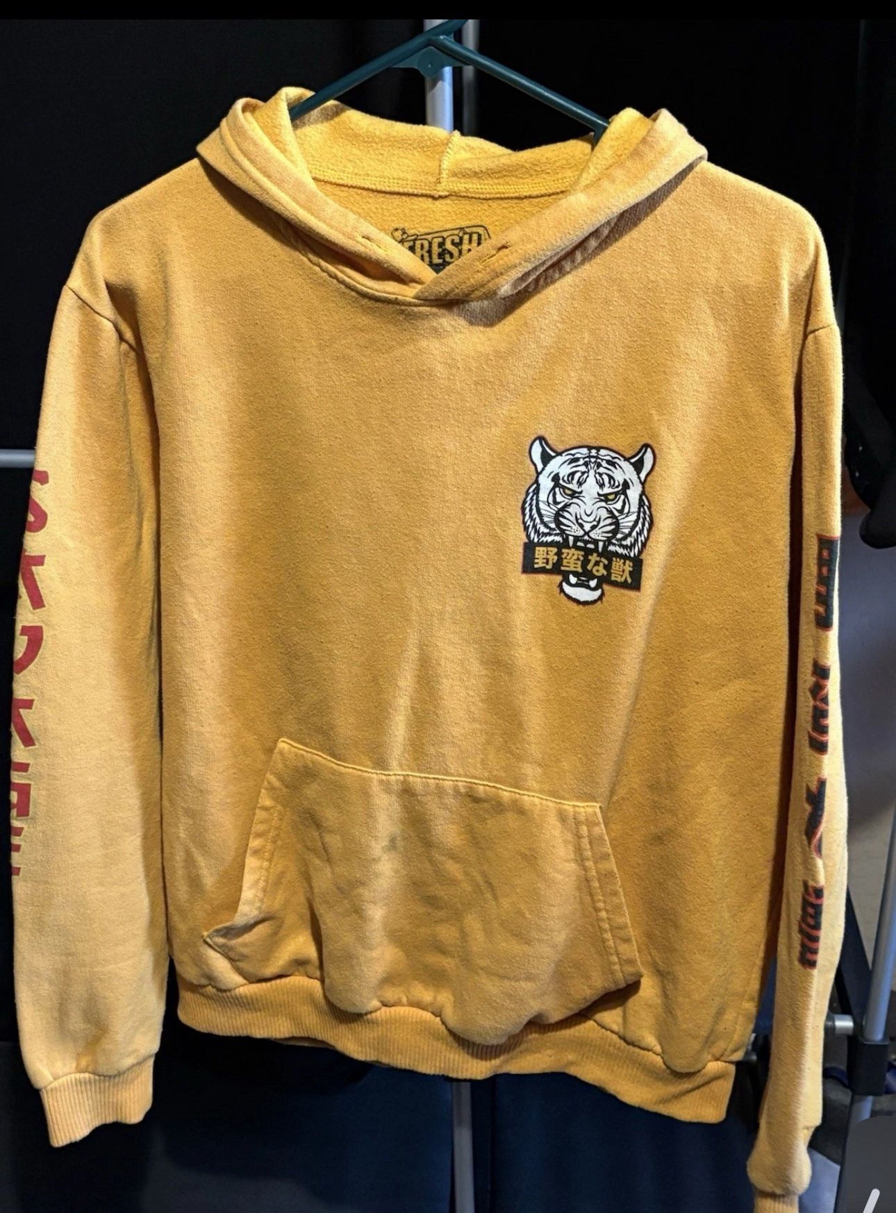 Stained. Brand: fresh laundry. Men’s size large. Yellow white tiger hoodie.