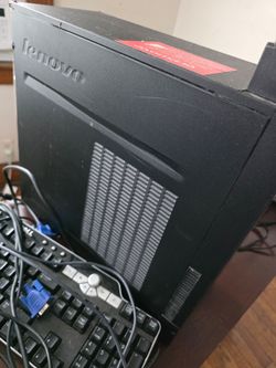 Lenovo desktop tower PC with keyboard, printer, and TV-DVD combo.