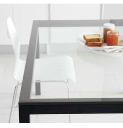 Crate and Barrel Parsons Clear Glass Top Dining Table.