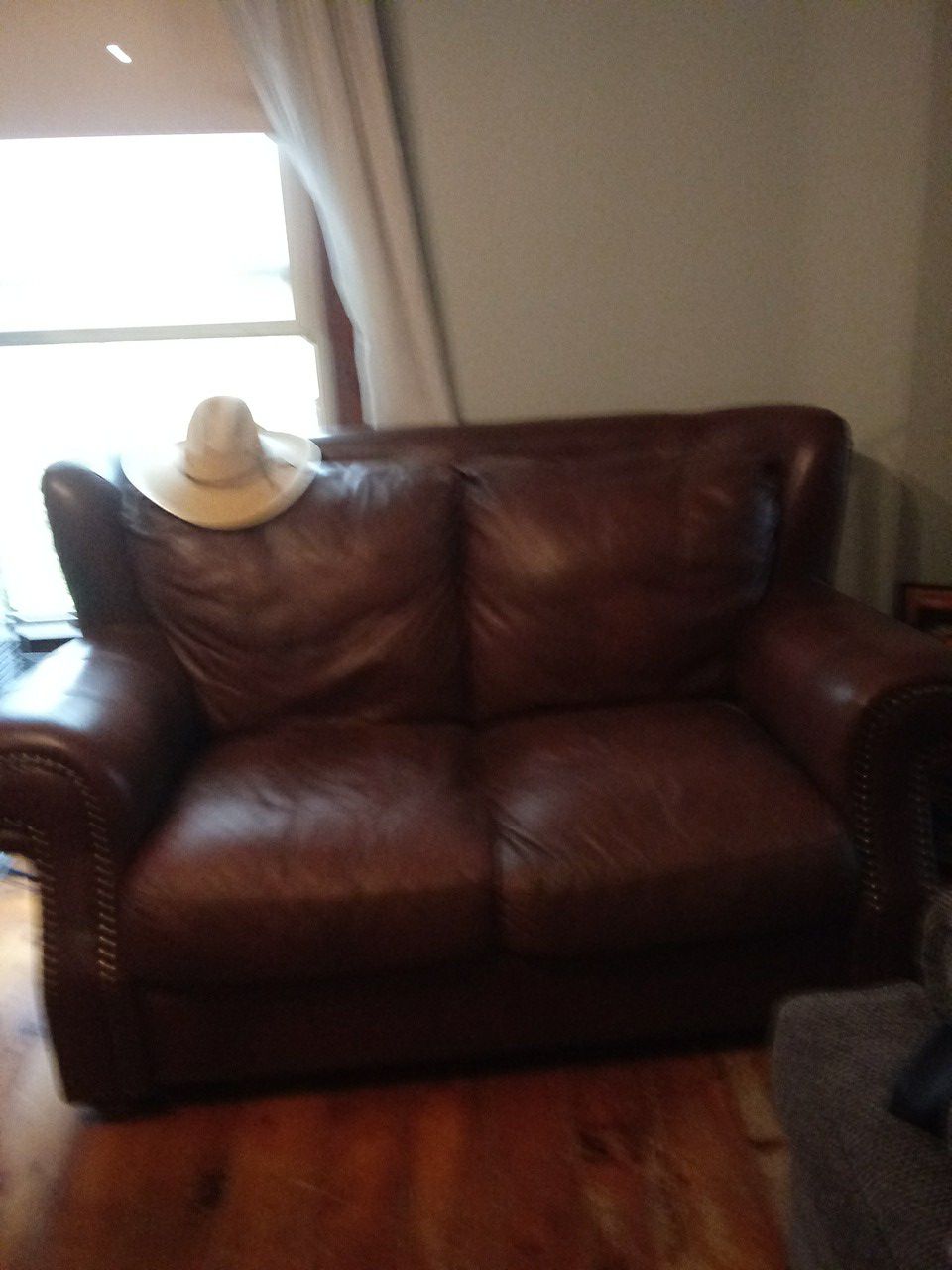 Free Brown leather loveseat. Good condition