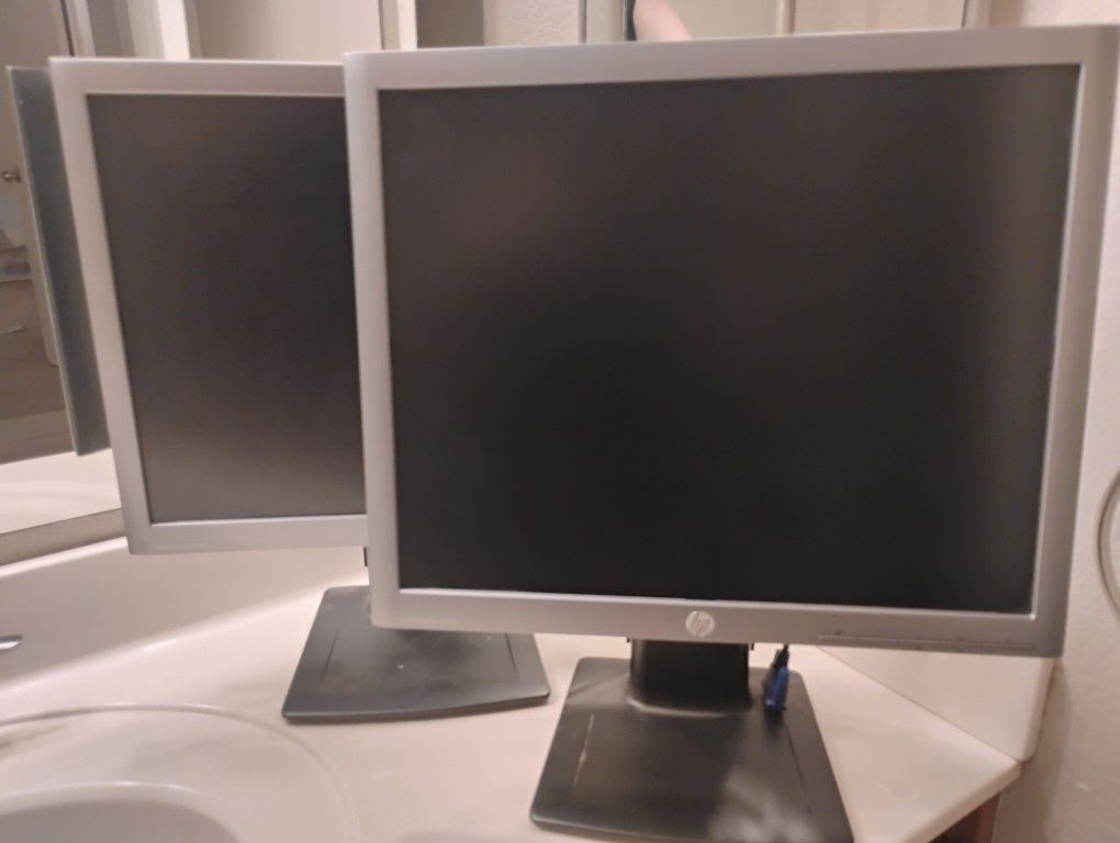Two HP E190 I IPS Display Monitors.