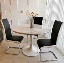 3 black chairs with white trim and metal legs