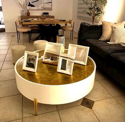 This round white and gold coffee table resembles styles like the Liv & Skye gold leaf top table. 46,5in