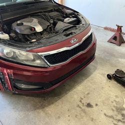 Red 2012 Kia Optima SX bumper