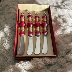 New open box. The Pier 1 Canape Knife Set includes a set of knives with a length of 5 inches. The knives come in a red and orange ball design and are 