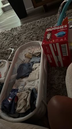 Free 0-3 month baby clothes, portable sleeper and a pack of size 1 diapers.