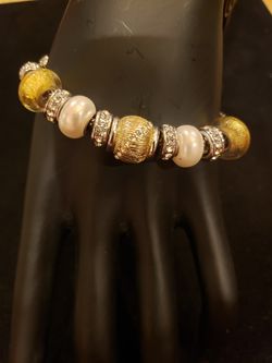 Elegant silver tone bracelet with CZ rhinestones, faux pearls and glass gold beads. 9 in long. Lobster clasp.
