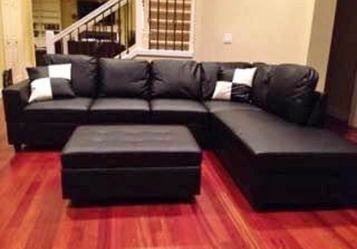 Black leather sectional couch and ottoman