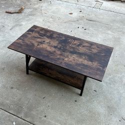 Wooden table with dark brown, finish and black metal legs