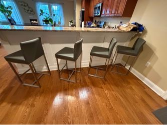 4 bar height stools.  Gray leather.  Great condition.  Available for pick up June 7th
