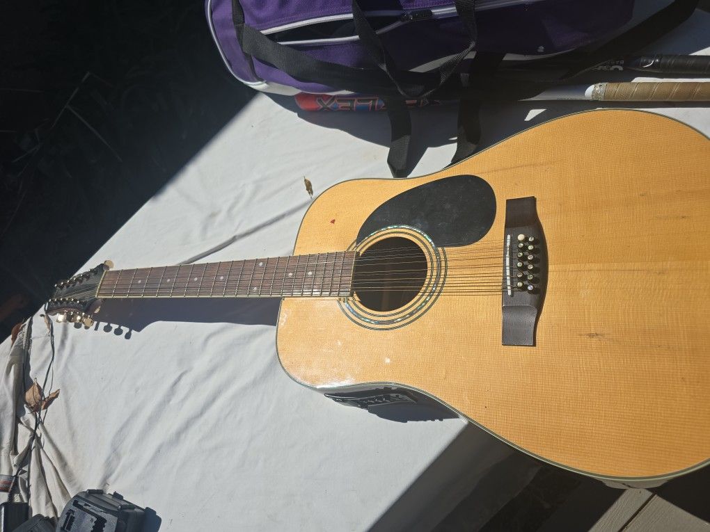 Mitchell twelve string Guitar. Has some bellying. Unable to open the battery on the side