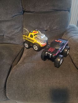 2  toy trucks yellow works black cant find control but still can play.