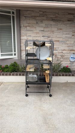 Chinchilla cage for sale. Used but great condition. Extra wood ledges plus 14” running wheel. Can be used for chinchilla, rats, guinea pigs, etc.