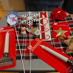 Assorted New Christmas Items including gift bags, bows , Christmas Window Clings, Santa Oven Glove, LED Window Candles,  About 3 Dozen Items