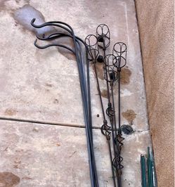 4 Tiki torches and 5 plant hangers