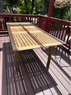 Teak dining table with extension