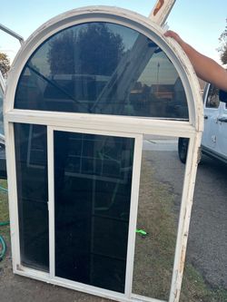 Arched Top Sliding Window Unit White Frame . Tinted window   70” by 47 1/2”