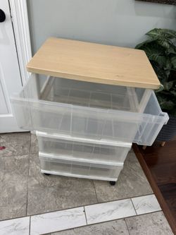 Good condition  Plastic storage with rolling wheels 