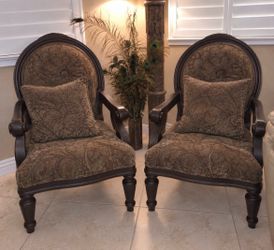 Two velvet chairs with pillows