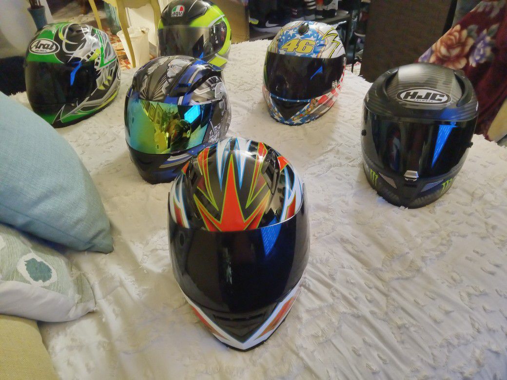 A collection of motorcycle racing helmets All extra large