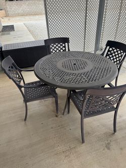 Patio table with cushions, umbrella and a lazy Susan