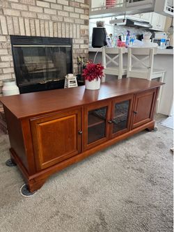 Gorgeous solid wood tv stand with doors.. and shelf’s.. perfect condition