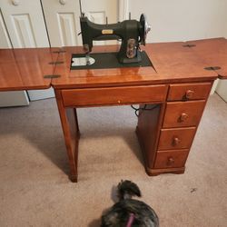 White Sewing Machine In Desk. 