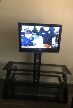 TV con la mesita color negro y de cristal casi nuevos